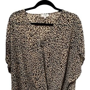 Andora Boutique- Thin Silk like shirt, with a twist near the bottom.